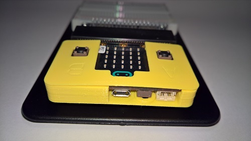 Kimturcase M1 with Microbit inserted in an edge connector next to breadboard